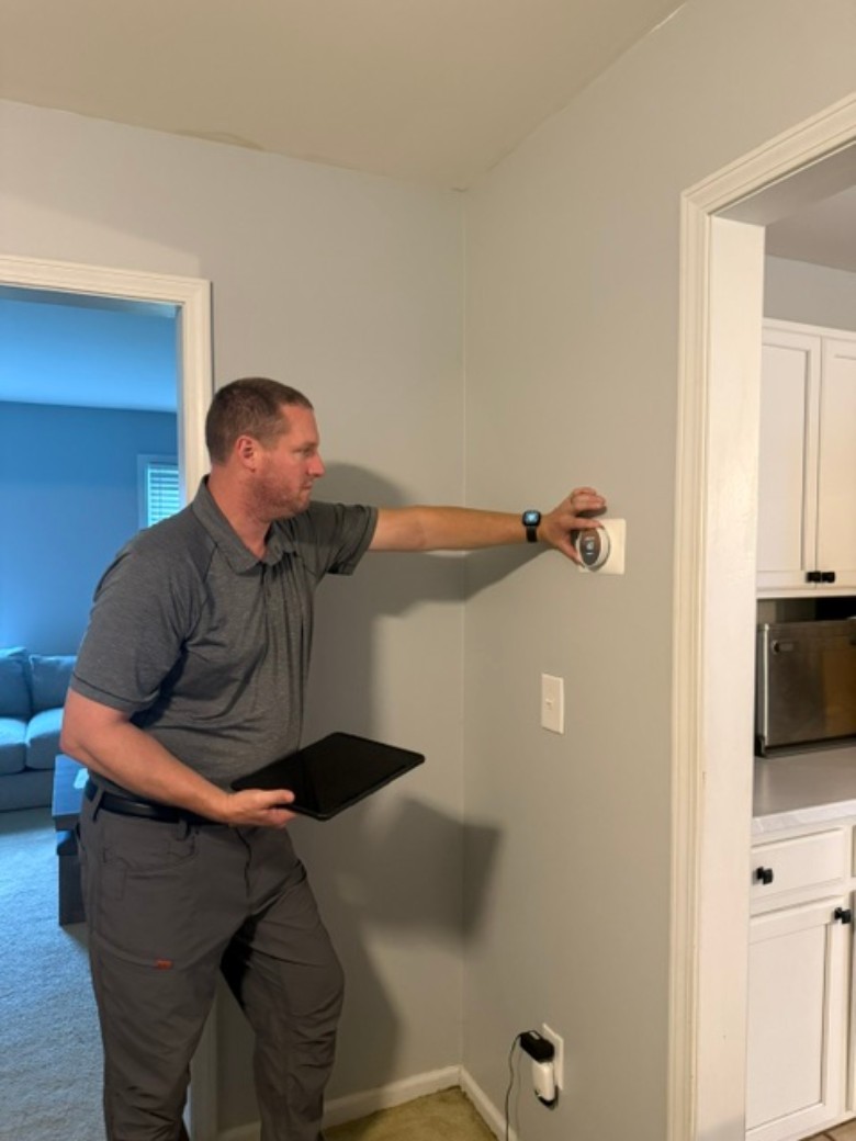 Concierge services can involve adjusting heating and cooling, receiving packages, meeting contractors, vehicle preparation, and more. man placing wood outside home