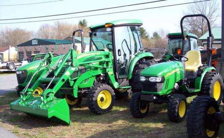 a selection of green tractors on display outdoors