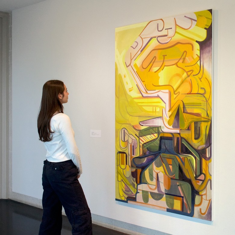 woman looks at painting