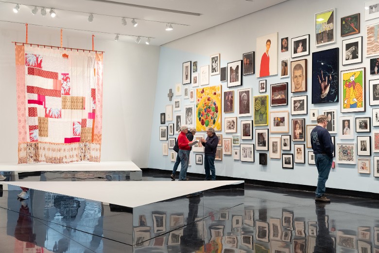 people looking at paintings