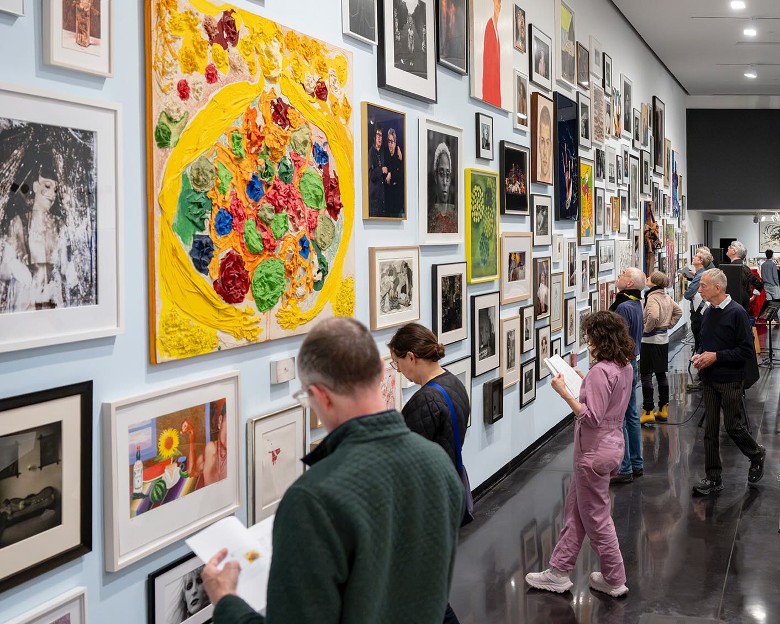 people looking at paintings