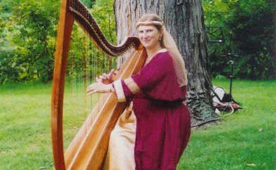 woman in a red robe playing the harp
