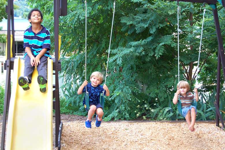 kids on swings and a slide