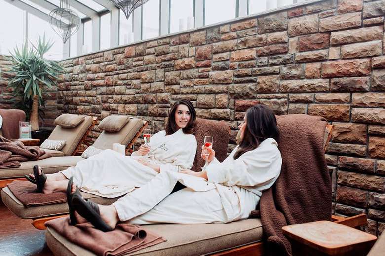 two women in robes at a spa