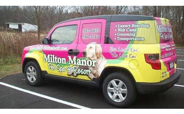multi-colored car with milton manor's logo and contact information on the side