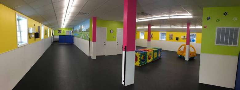 doggie daycare room with rubber floors and brightly colored walls