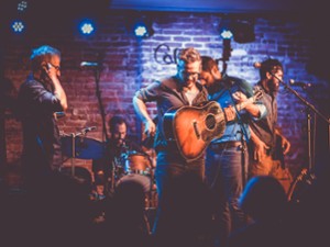 Band on stage with drums and guitar