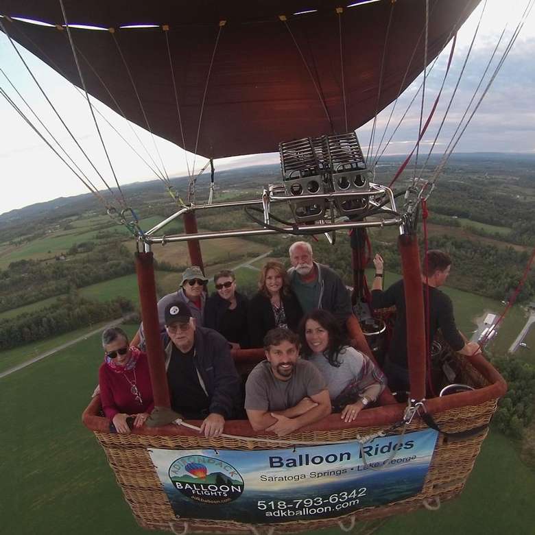 group of people in a hot air balloon basket