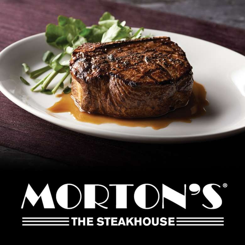 steak on a plate with brown sauce and the morton's logo