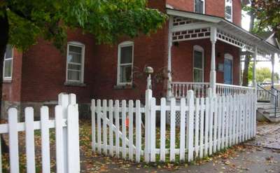 exterior of franklin community center, a red brick building with a white picket fence