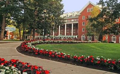 exterior of the gideon putnam with a flower-lined sidewalk leading up to the entrance