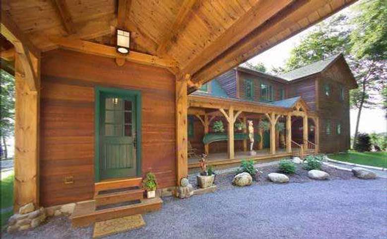exterior of a wooden home with dark green accents