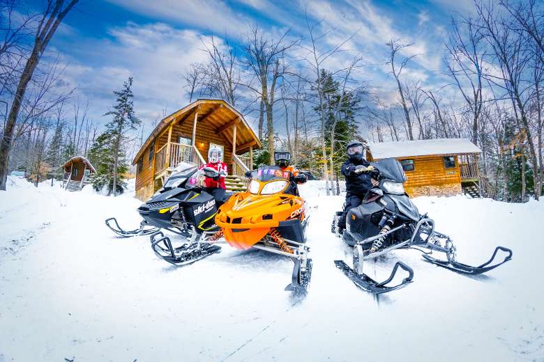 snowmobiles in front of cabins