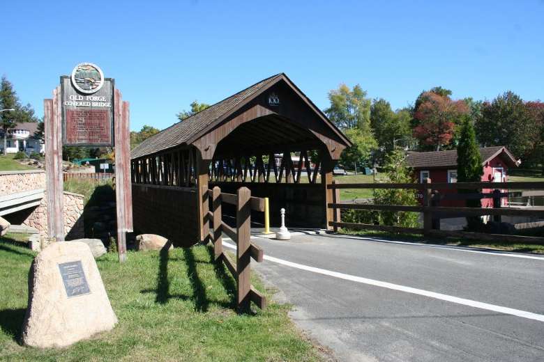 covered bridge and Old Forge sign