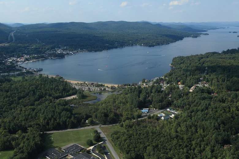 aerial view of a wooded area and a lake