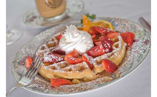 Breakfast Special of strawberries and waffle with whipped cream 
