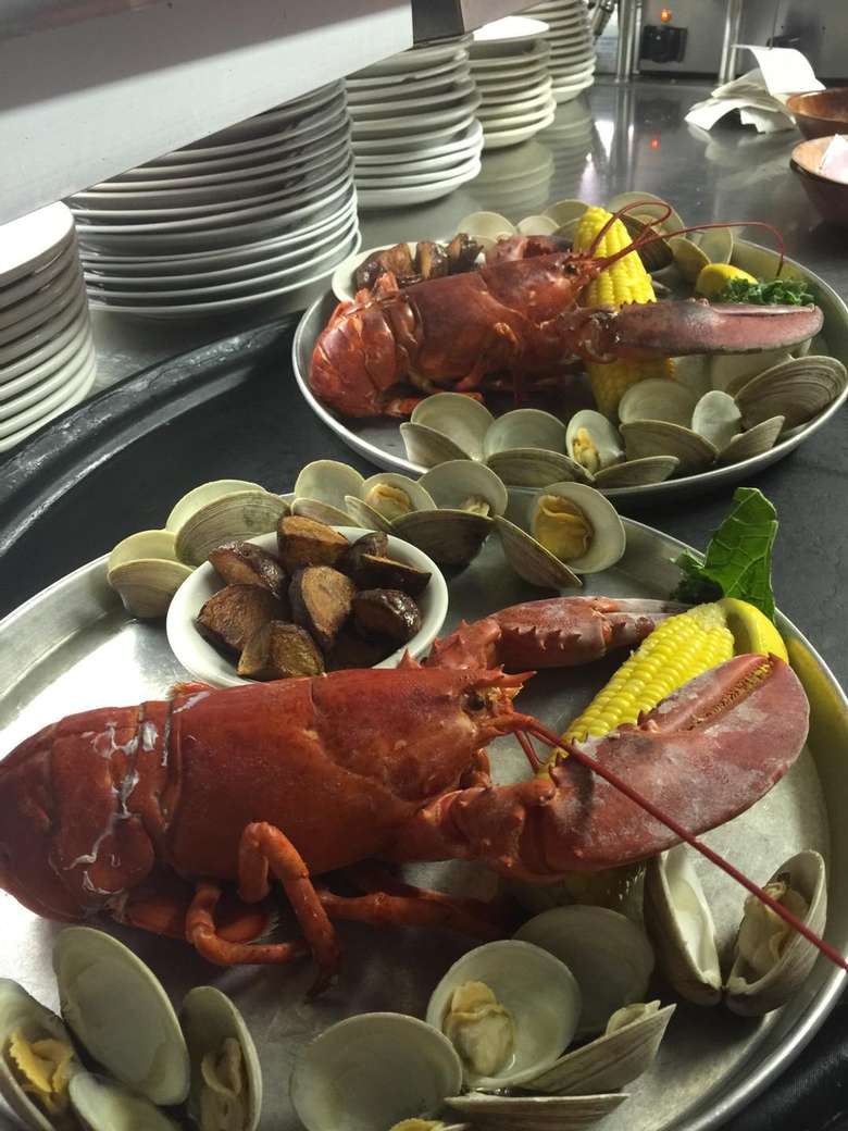 two plates with lobster and clams
