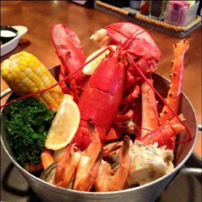 metal pot with lobster and seafood