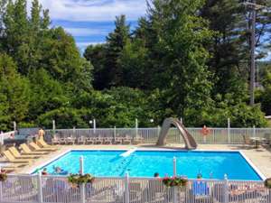 pool with slide and a hot tub