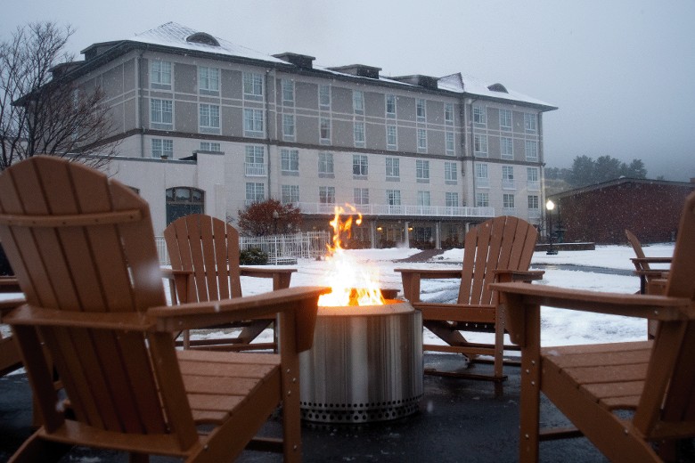 Hotel in the snow with a warm on-site firepit.