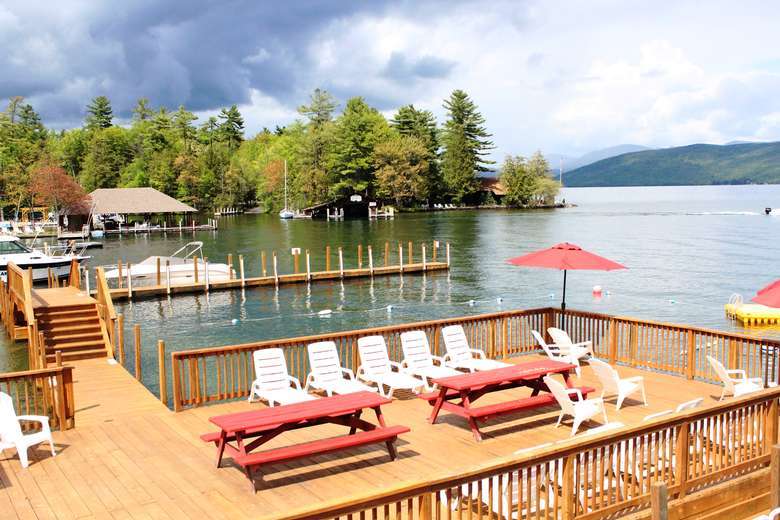 patio deck with chairs by a lake