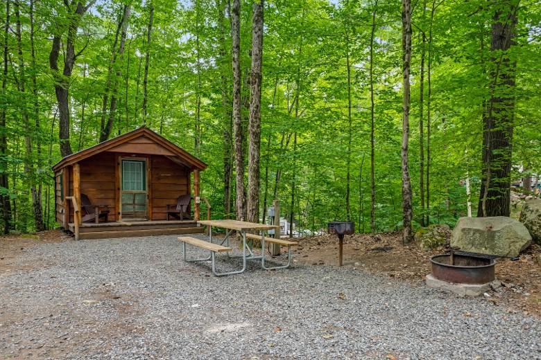 Camping Cabin with picnic table and fire ring.