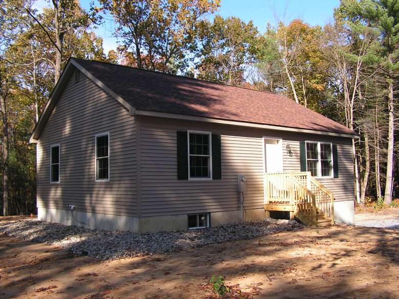 small house with new tan siding