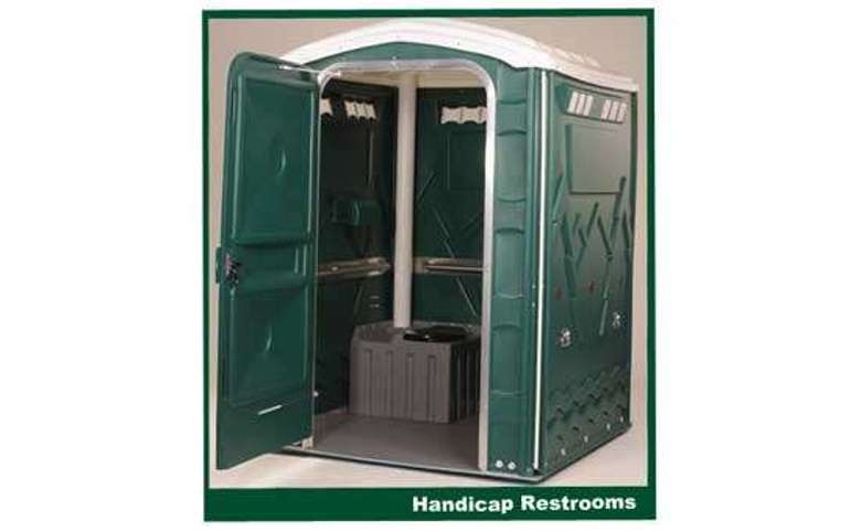 a large green handicap accessible portable restroom unit