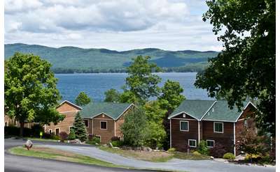 semi aerial view of cottages by lake