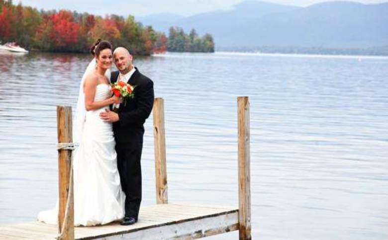Couple on dock in wedding attire