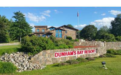 the stone entrance sign at Dunham's Bay Resort