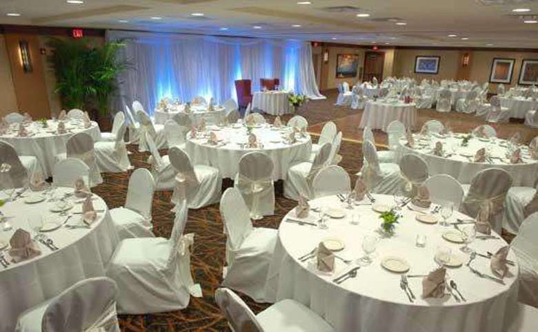 tables set up for a wedding with white linens and tablecloths