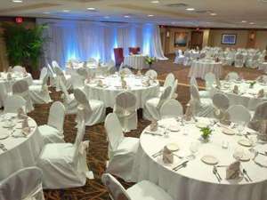 tables set up for a wedding with white linens and tablecloths