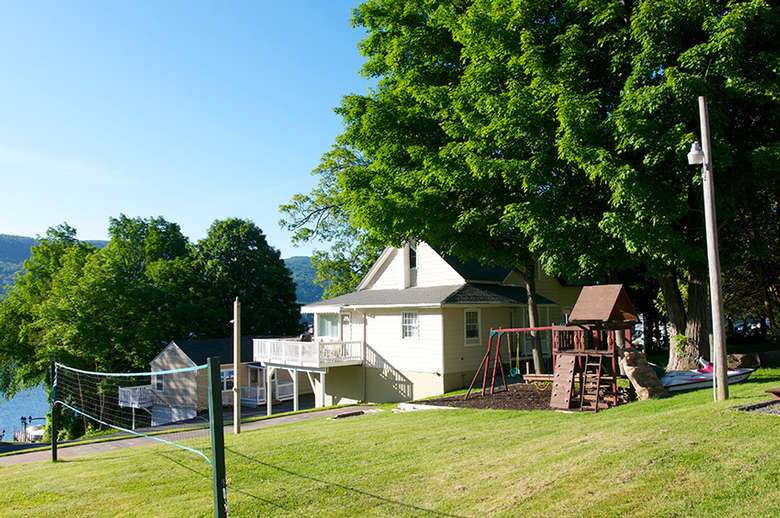 a house with a playground and a volleyball net