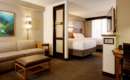 room with two queen beds and separate seating area with couch and table