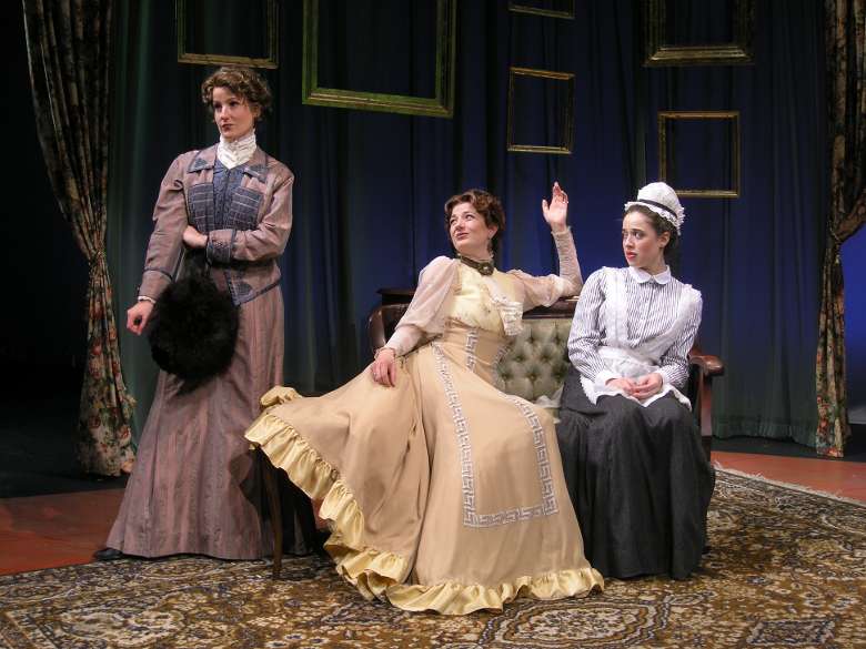 women in period costumes on stage