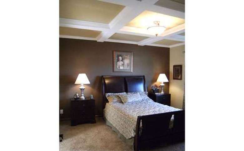 bedroom with accent beams on the ceiling