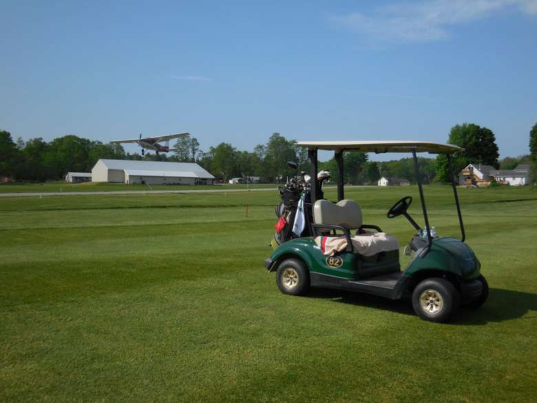 golf cart parked on a green