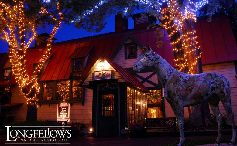 exterior of longfellows at dusk with christmas lights on the trees