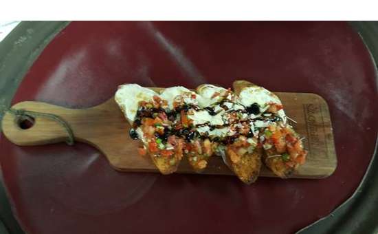 four pieces of brushetta on a wooden board