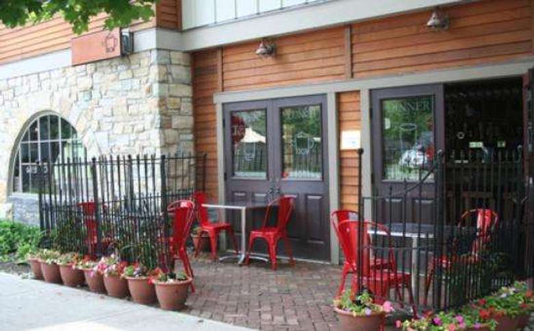 an outdoor patio with red chairs at a restaurant