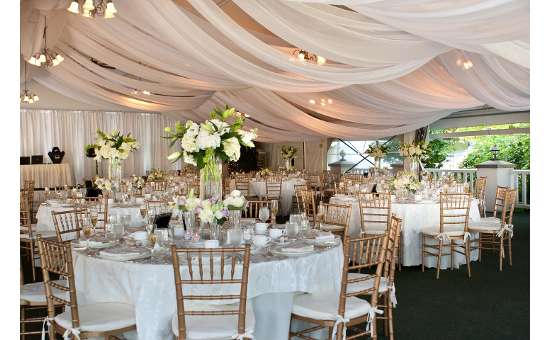 a wedding reception tent with tables