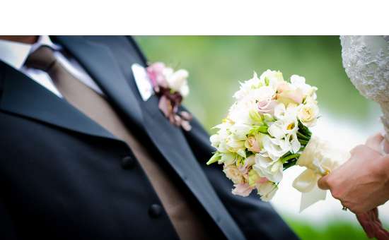groom and bride with flowers