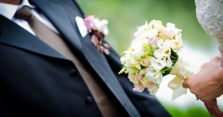 groom and bride with flowers