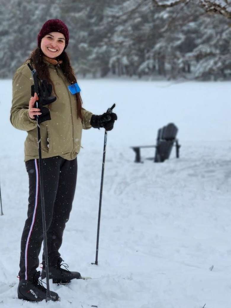 woman with hiking poles in snow