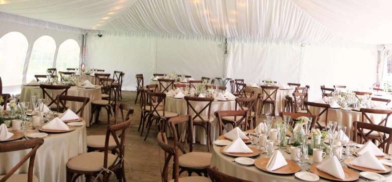 a large white tent with tables set up for a special event