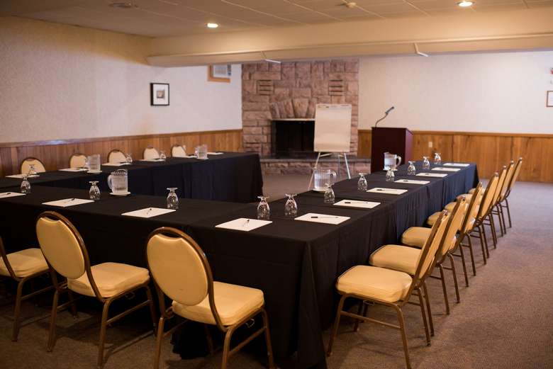 tables and a podium set up for a presentation