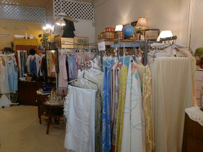 vintage shirts and clothing on racks in a store