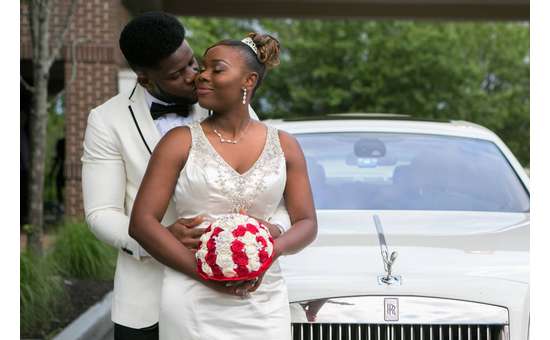 bride and groom near a white car