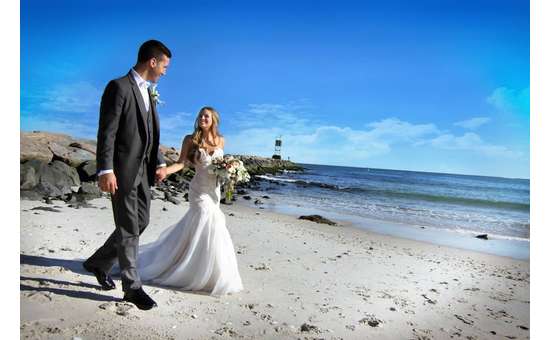 bride and groom walking on a beach